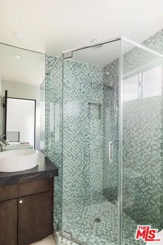 a bathroom with a shower and a sink