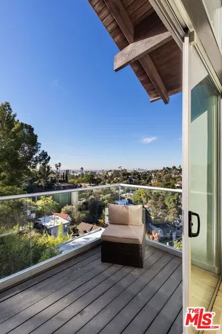 a view of roof deck with seating space and city view