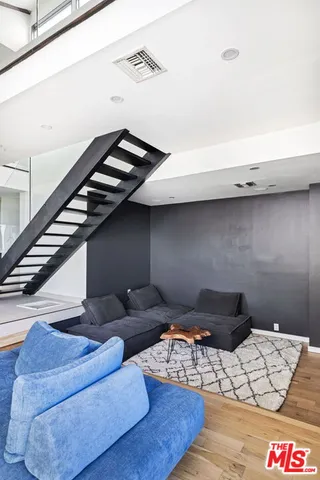 a living room with furniture and stairs