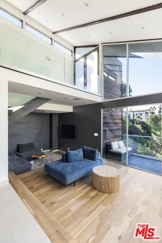 a living room with furniture and a floor to ceiling window