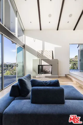 a bedroom with furniture and a large window