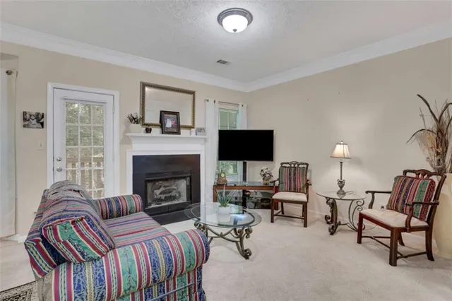 a living room with furniture fireplace and flat screen tv