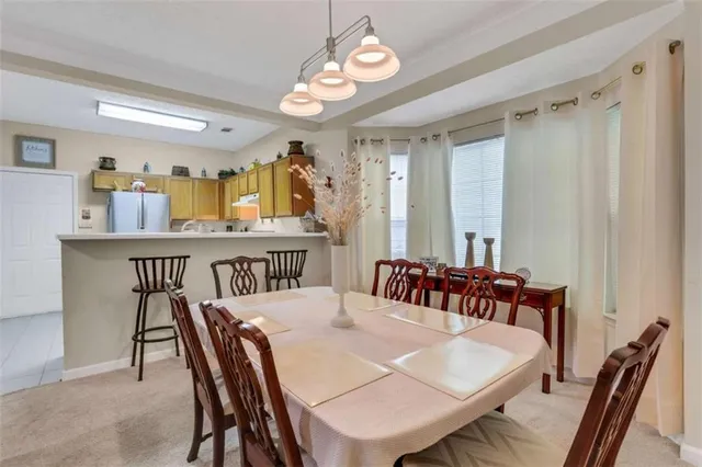 a view of a dining room with furniture and a chandelier
