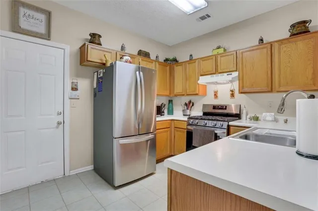 a kitchen with stainless steel appliances a refrigerator and a stove