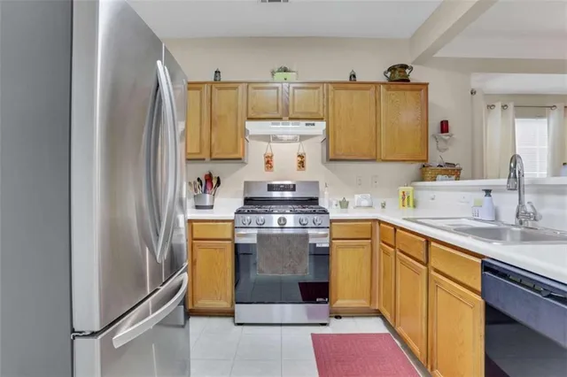 a kitchen with a stove top oven sink and cabinets