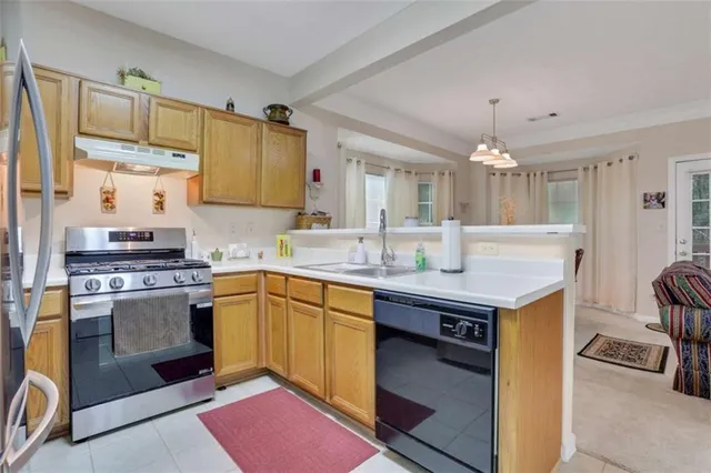 a kitchen with a sink stove and refrigerator