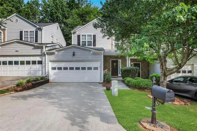 a front view of a house with a garden and plants