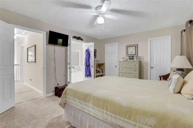 a spacious bedroom with a bed and a walk in closet