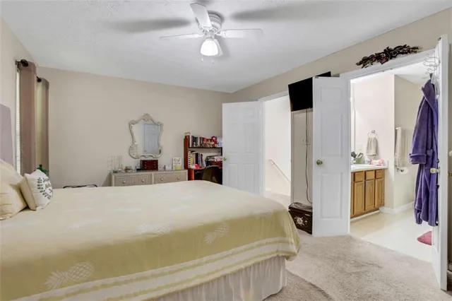 a bedroom with a large bed and a chandelier