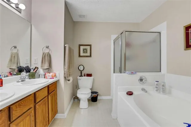 a bathroom with a double vanity sink mirror and toilet
