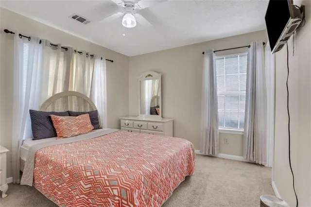 a bedroom with a large bed and a chandelier