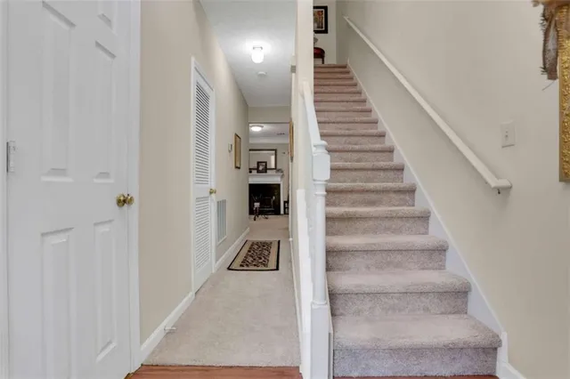 a view of a hallway with white walls and entryway