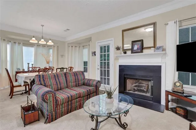 a living room with furniture fireplace and flat screen tv