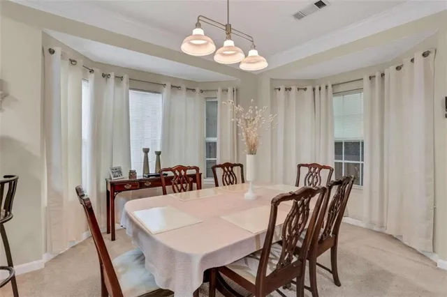 a view of a dining room with furniture and chandelier