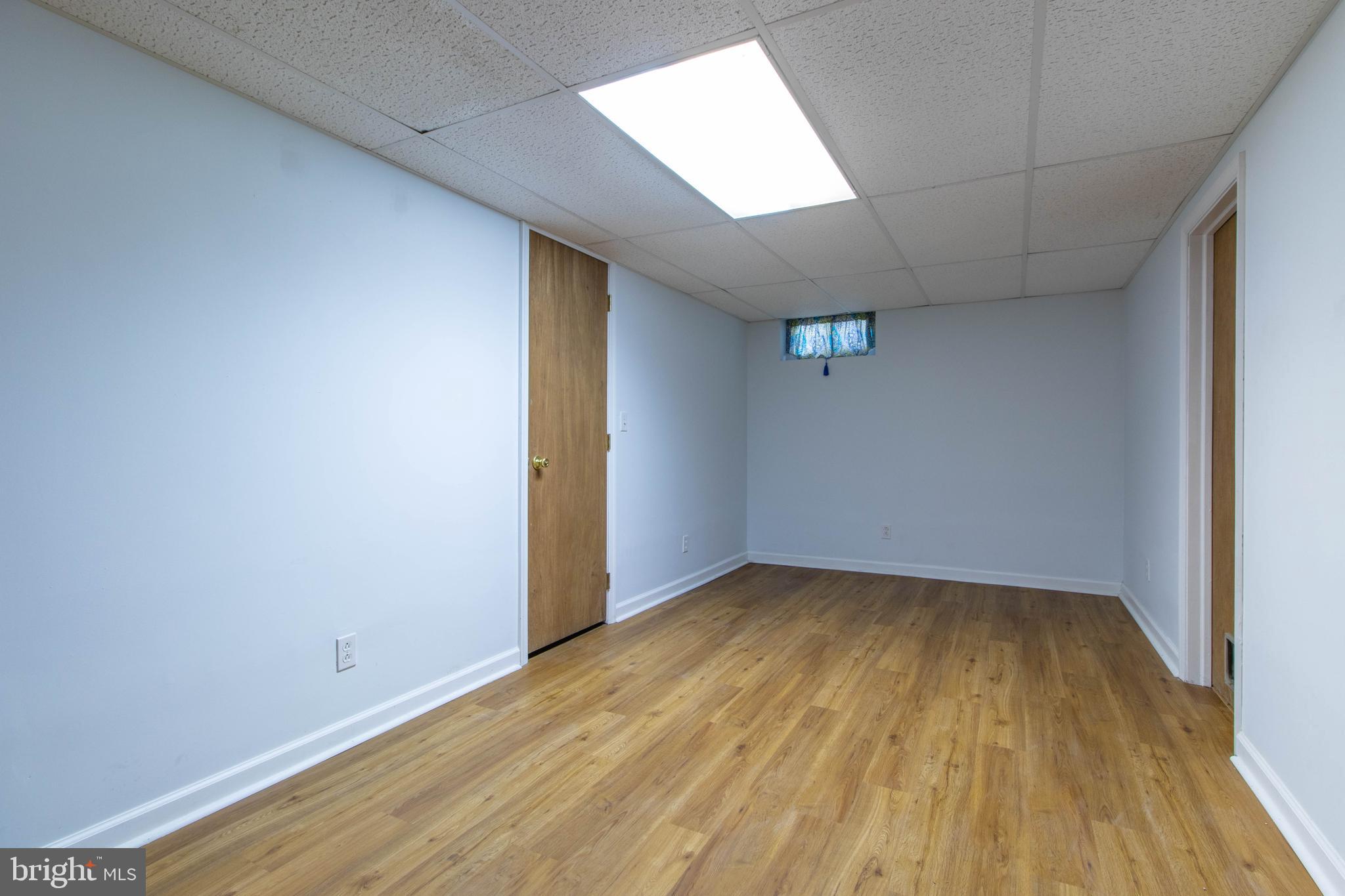 608 Rosedale Road Kennett Square, PA 19348 - Photo 22 of 30 an empty room with wooden floor and windows