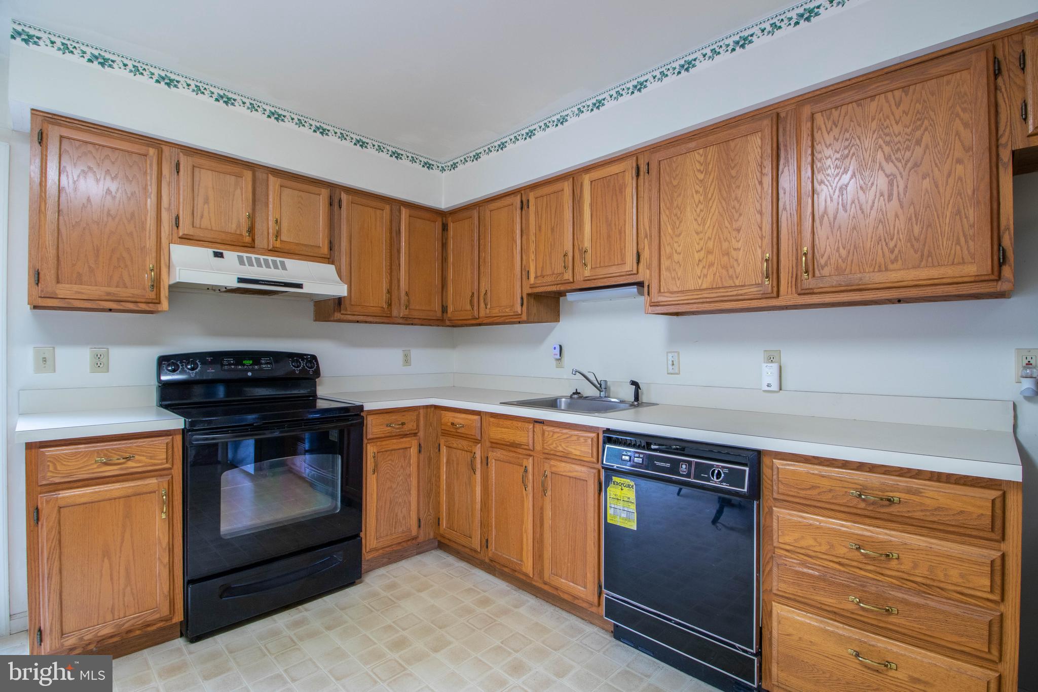 608 Rosedale Road Kennett Square, PA 19348 - Photo 6 of 30 a kitchen with stainless steel appliances granite countertop wooden cabinets a stove a sink and dishwasher