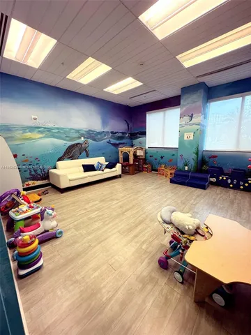 a play room with toys and a ceiling fan