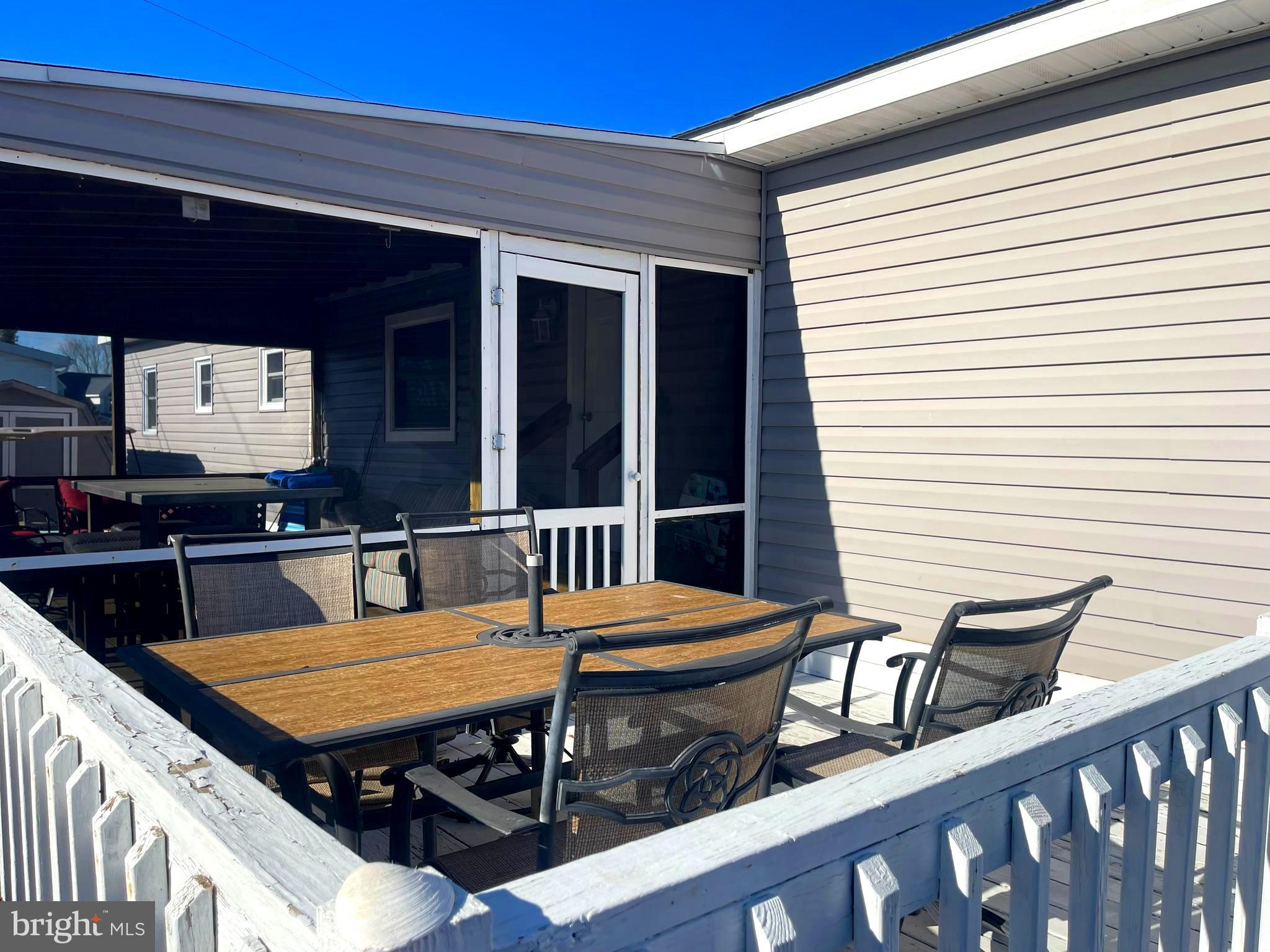 21720 B Street Rehoboth Beach, DE 19971 - Photo 3 of 23 a balcony with table and chairs