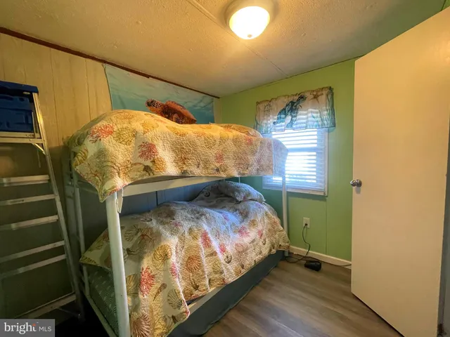 a bed sitting in a bedroom next to a window
