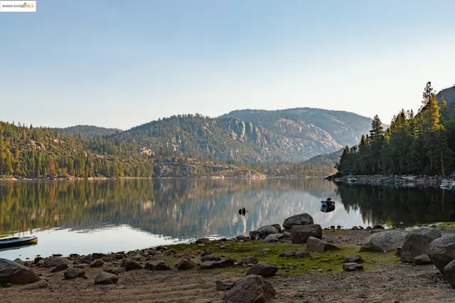 a view of mountain with sunset in background
