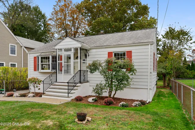 a front view of a house with a yard and porch