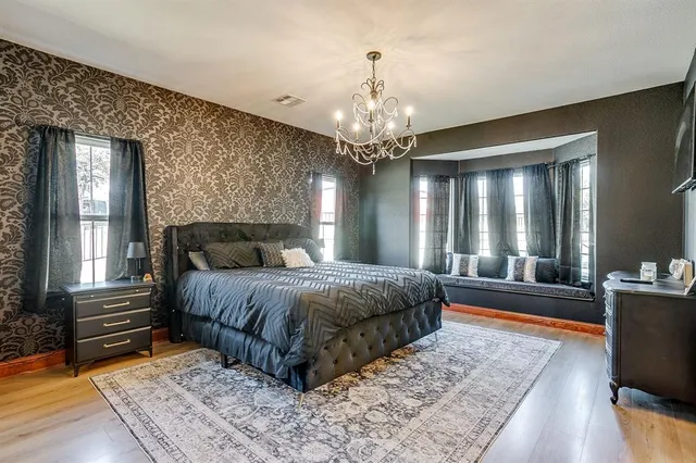 a spacious bedroom with a large bed and a dresser