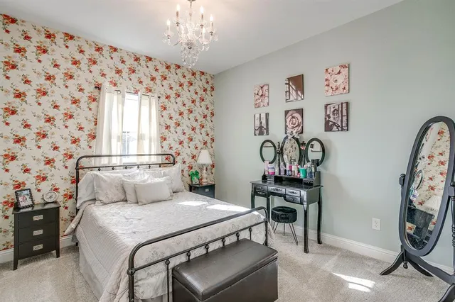 a bedroom with a bed and a chandelier