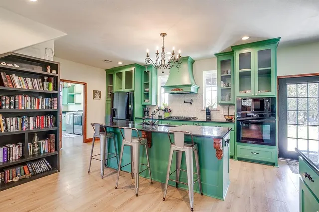 a kitchen with stainless steel appliances granite countertop a stove a sink dishwasher and a wooden cabinets