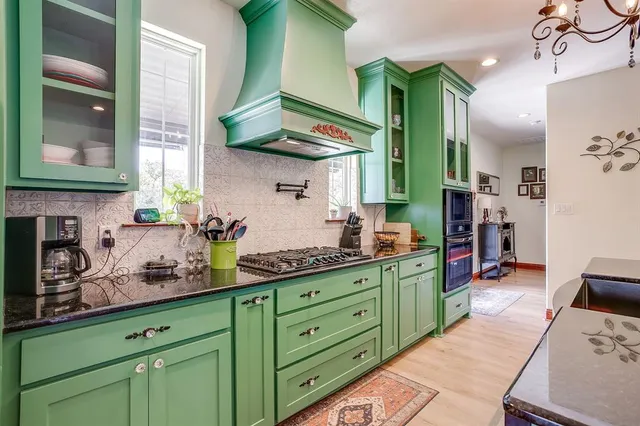 a kitchen with cabinets a sink and a stove