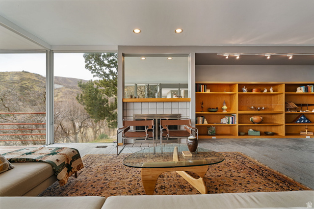 1856 Fort Canyon Road Alpine, UT 84004 - Photo 39 of 49 Living area featuring expansive windows, built-in shelving, recessed lighting, and a tiled fireplace surround with a wood mantel