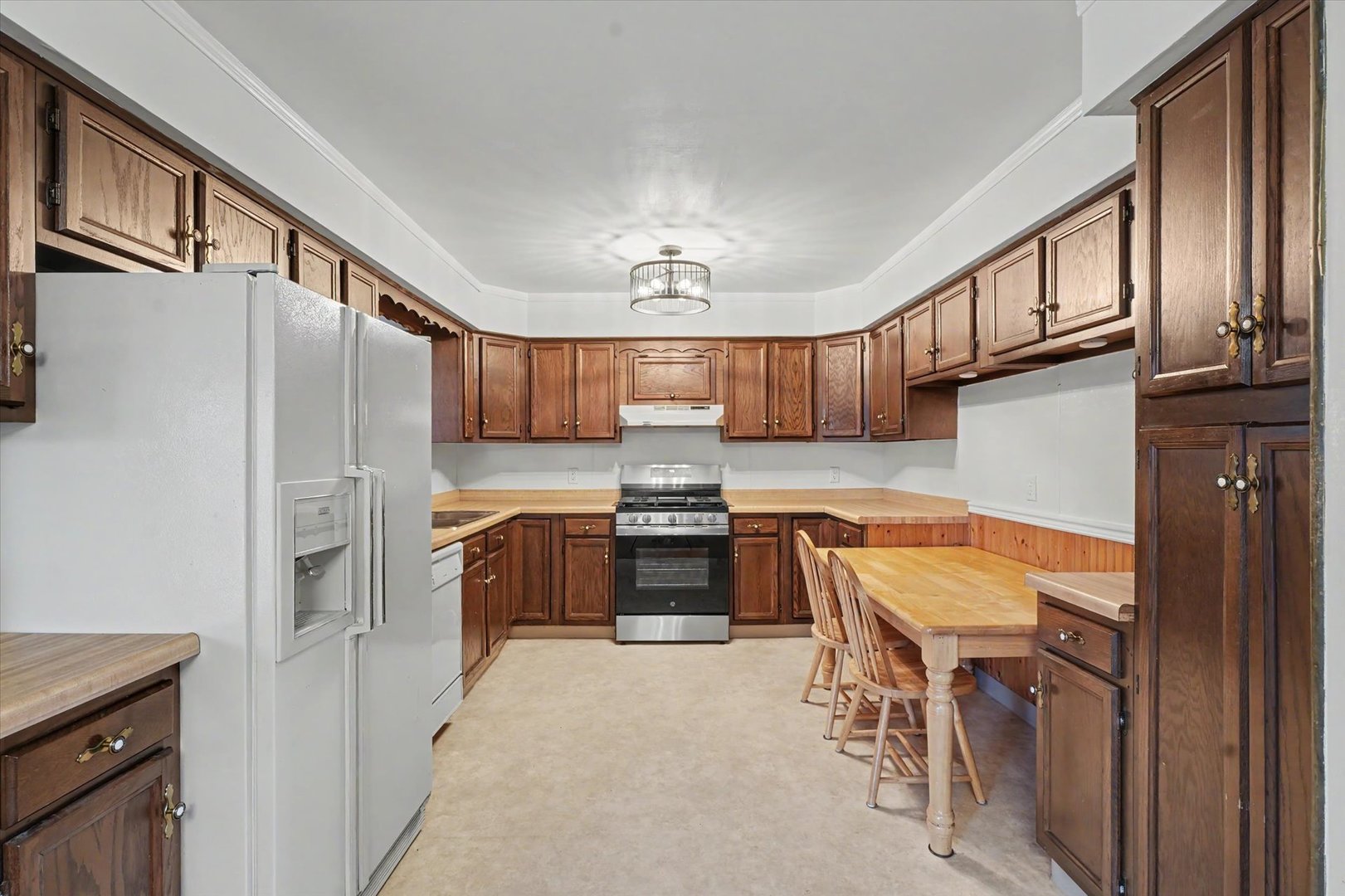 1605 Grange Drive Rantoul, IL 61866 - Photo 11 of 26 a kitchen with stainless steel appliances granite countertop a refrigerator a stove and a sink with cabinets