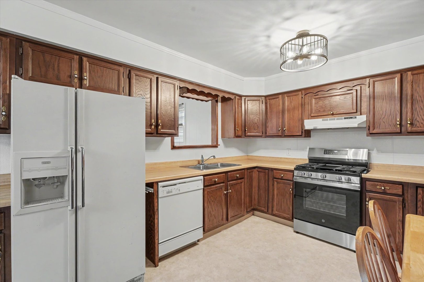 1605 Grange Drive Rantoul, IL 61866 - Photo 12 of 26 a kitchen with stainless steel appliances granite countertop a refrigerator sink and cabinets