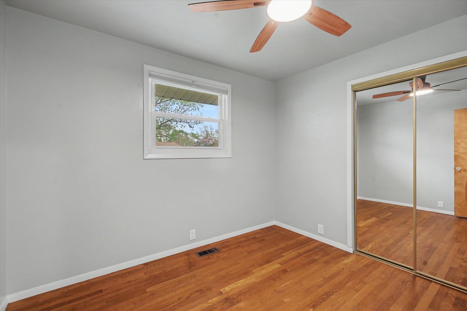 1605 Grange Drive Rantoul, IL 61866 - Photo 16 of 26 an empty room with a ceiling fan and wooden floor