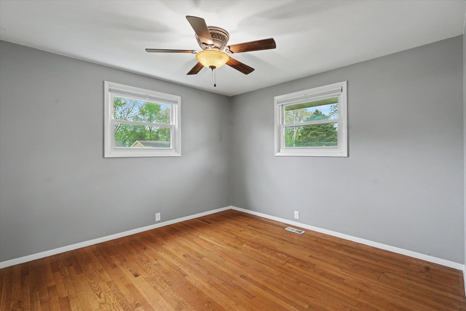 1605 Grange Drive Rantoul, IL 61866 - Photo 18 of 26 a view of room with wooden floor and ceiling fan