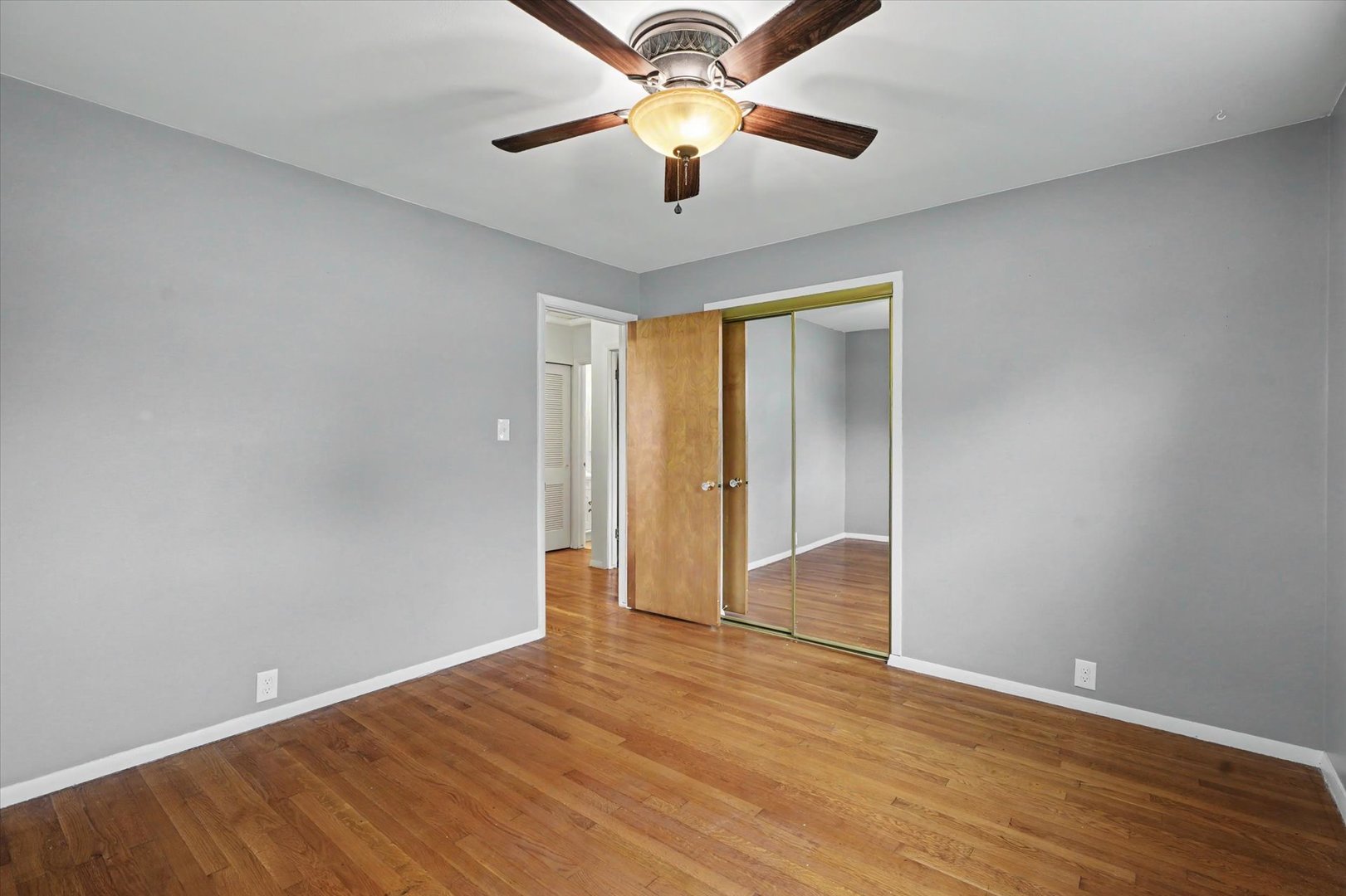 1605 Grange Drive Rantoul, IL 61866 - Photo 19 of 26 a view of an empty room with window and a chandelier fan