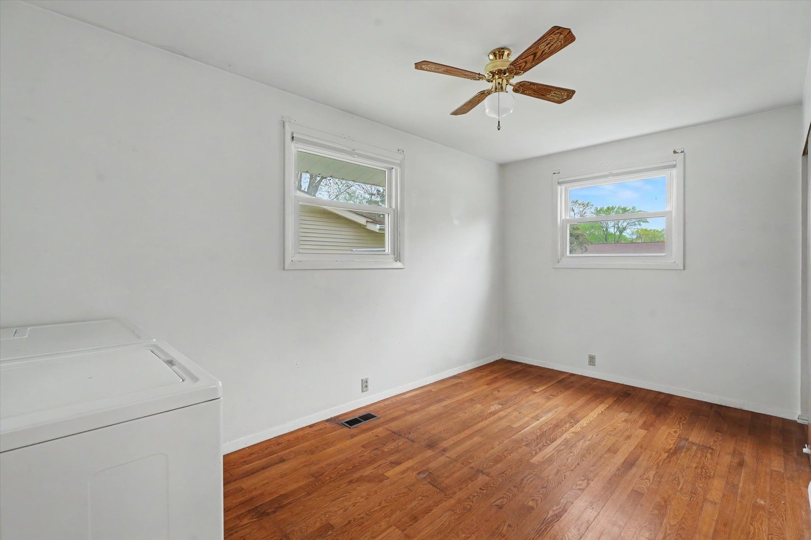 1605 Grange Drive Rantoul, IL 61866 - Photo 20 of 26 an empty room with a ceiling fan and a window