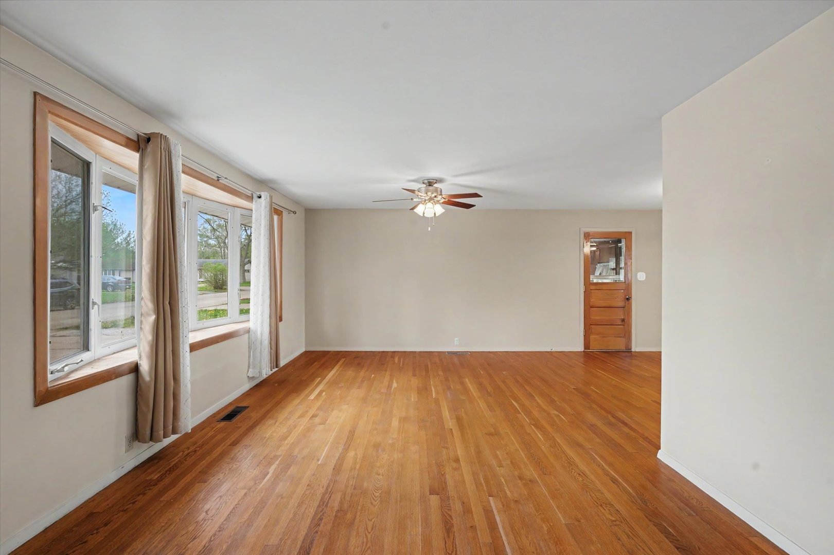 1605 Grange Drive Rantoul, IL 61866 - Photo 6 of 26 a view of empty room with wooden floor and fan