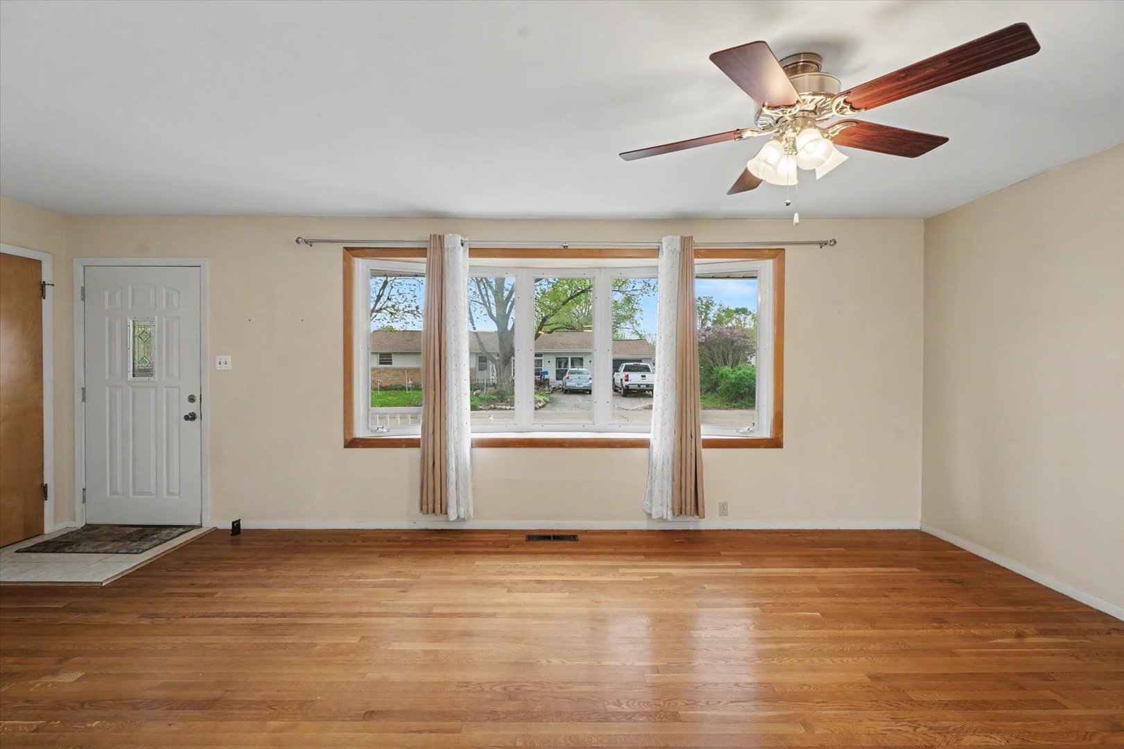 1605 Grange Drive Rantoul, IL 61866 - Photo 7 of 26 a view of an empty room with wooden floor and a window