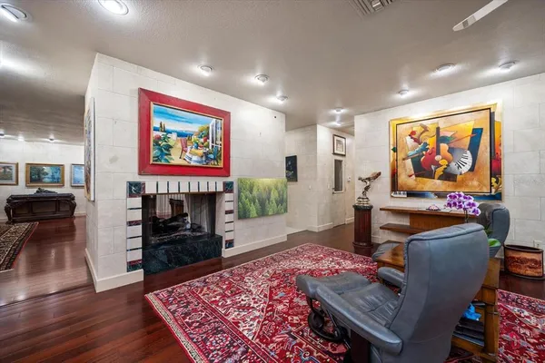 a dining room with furniture a rug and wooden floor