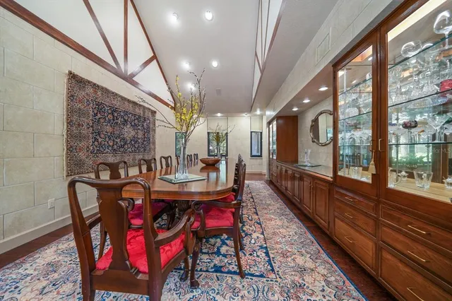 a bedroom with a bed and a dresser next to a window