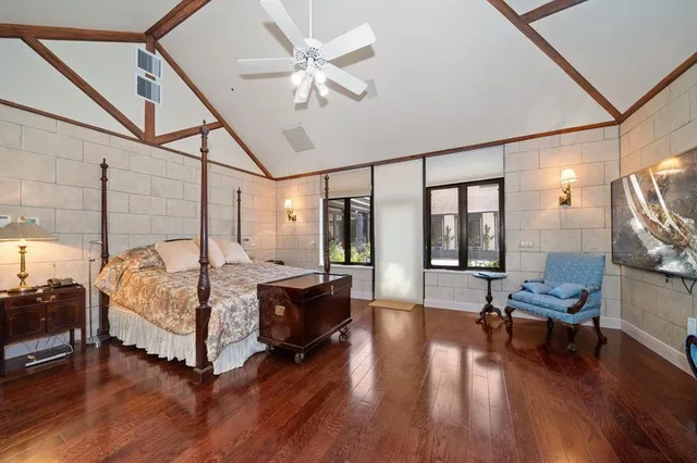 a bedroom with a bed and a wall painting