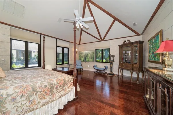 a bedroom with a bed and a wall painting