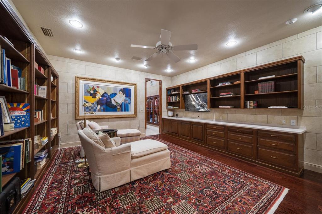 1835 Alicia Way Clearwater, FL 33764 - Photo 34 of 89 a living room with furniture and a bookshelf