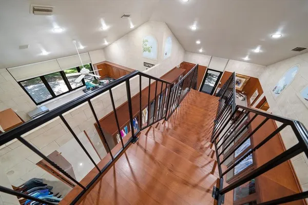 a living room with furniture kitchen view and a flat screen tv