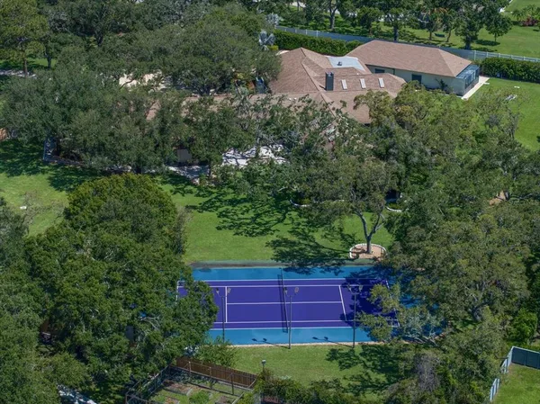 an aerial view of a house with yard and outdoor seating