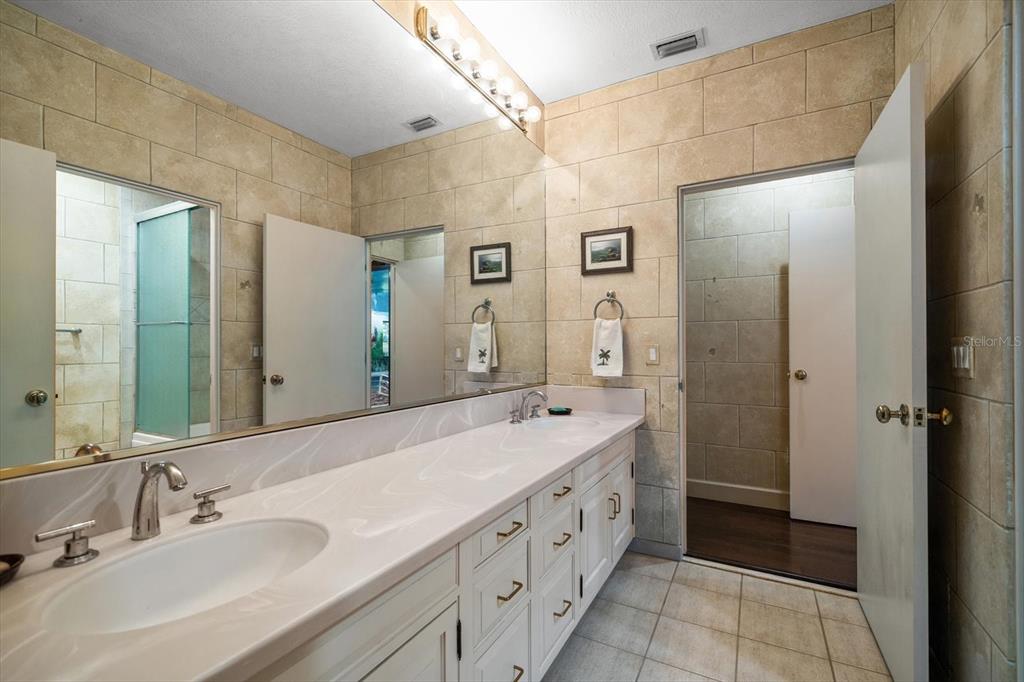 1835 Alicia Way Clearwater, FL 33764 - Photo 48 of 89 a spacious bathroom with a double vanity sink mirror and double