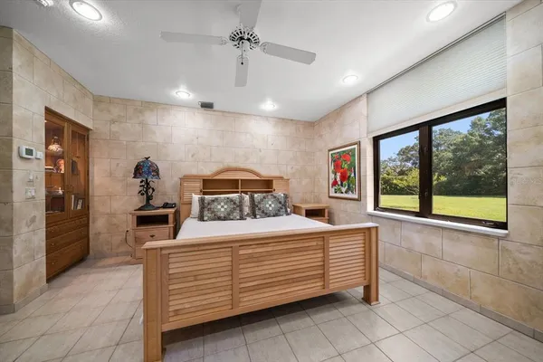 an aerial view of residential houses with outdoor space and trees