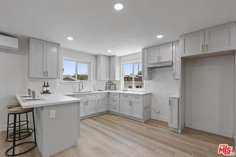 a kitchen with cabinets a sink and appliances in it