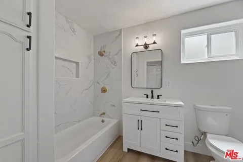 a bathroom with a sink toilet a tub and shower