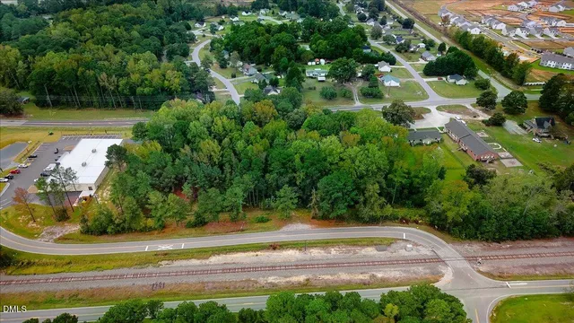 an aerial view of a house with a yard and outdoor seating